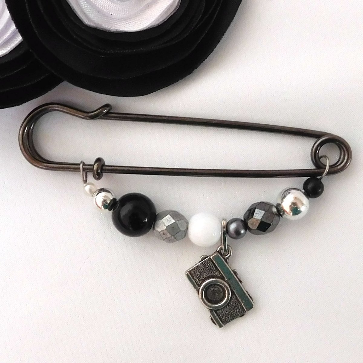 Ozdobný spínací špendlík, černobílá fotografie